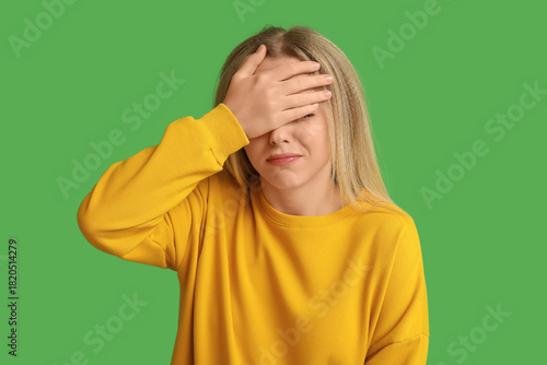 Young woman doing facepalm ...