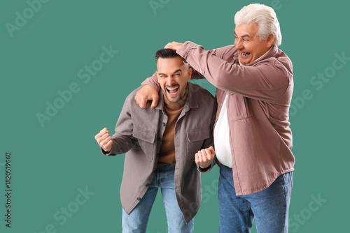 Mature man with his son hug...