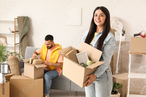 Happy young woman with box ...
