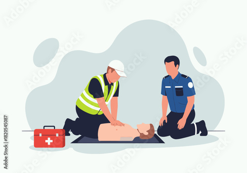 A responder in a yellow safety vest performs chest compressions on a training mannequin while a uniformed colleague kneels nearby next to a red first aid kit on the floor
