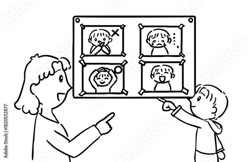 感情カードを使って気持ちを学ぶ子どもと支援員／モノクロ