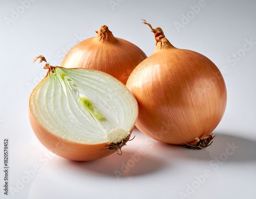 Wallpaper Mural Three onions, one sliced open, on a white surface, natural light Torontodigital.ca