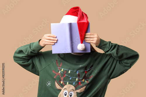 Young woman in Santa hat an...