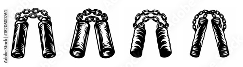 Four black and white nunchucks on a plain surface ready for martial arts training and practice