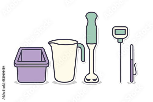 Essential kitchen tools set with immersion blender, measuring pitcher, and thermometer