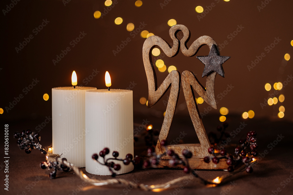 Fototapeta premium Advent white candles with decor in shiny lights closeup