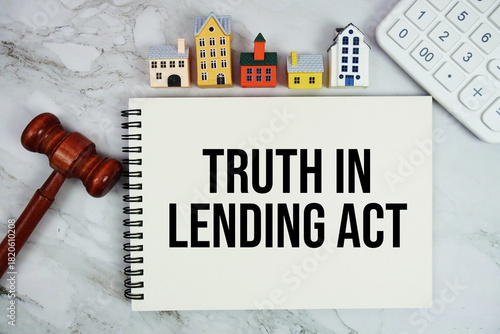 Фотография TILA Truth In Lending Act text written on notepad with house model, calculator a