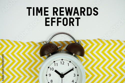 Vászonkép Time Rewards Effort text written on paper with alarm clock on yellow chevron bac
