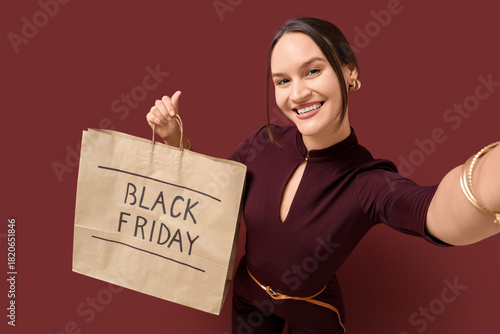 Happy young woman holding s...