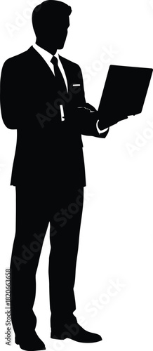 Silhouette of a businessman standing and holding a laptop computer
