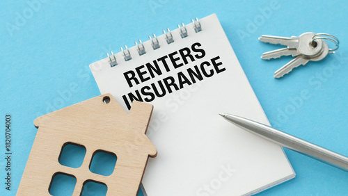 A house and a pen are on a blue background. The house is wooden and has a key on it. The pen is on the right side of the house. Concept of Renters Insurance