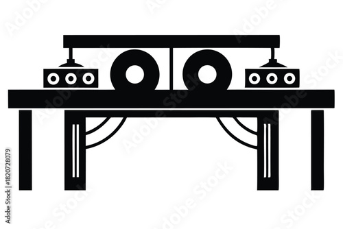 Black machine silhouette contains wheels with three holes on top of table design