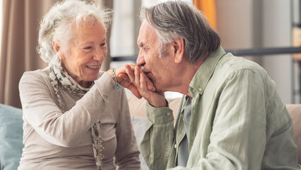 Old couple, kiss hand for valentines day, anniversary and celebration at home.