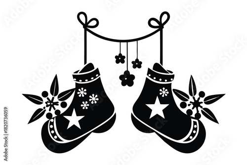 Black holiday stocking pair hangs with floral accents as a silhouette