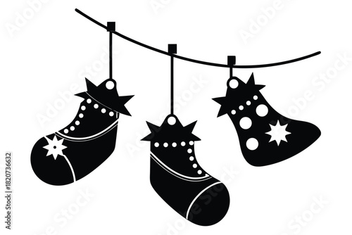 Three stylized black christmas stockings hang from a string with a white background