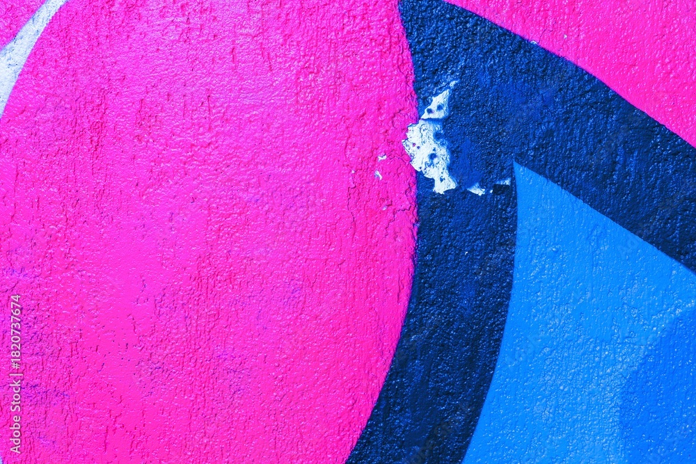 Obraz premium Abstract graffiti pattern with vibrant pink and blue colors. Funky, vibrant aesthetic, reminiscent of 90s street art. Urban walls, creative banners, digital art, modern 90s visuals.