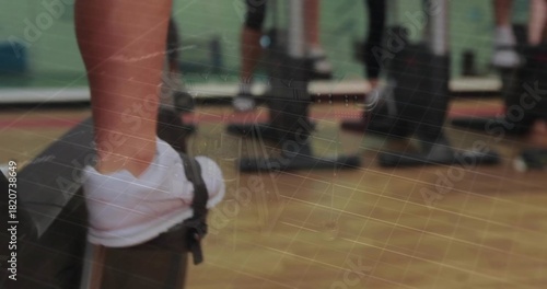 Stepping participant's leg pressing on black step at gym, with white shoe and strap, copy space