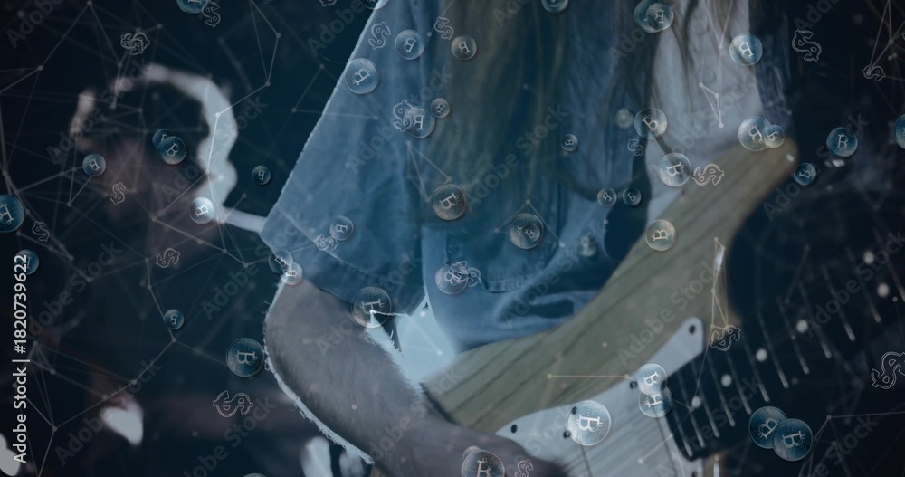 Fototapeta premium Strumming guitarist in faded denim shirt playing electric guitar on dim stage, with Bitcoin bubbles