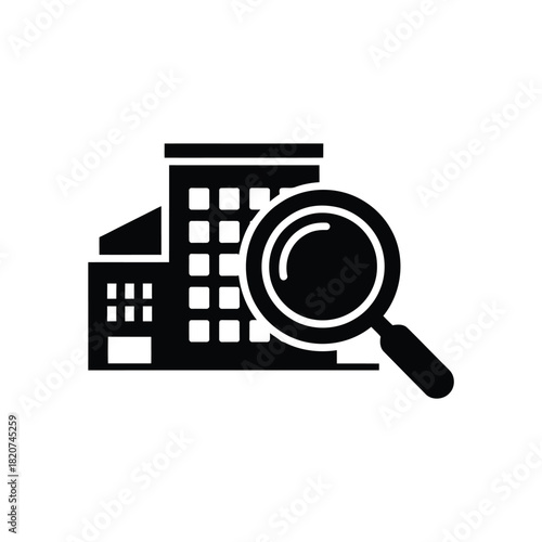 Magnifying glass over building icon for real estate search