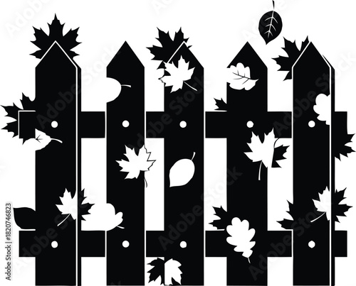 Black silhouette of a picket fence with falling autumn leaves