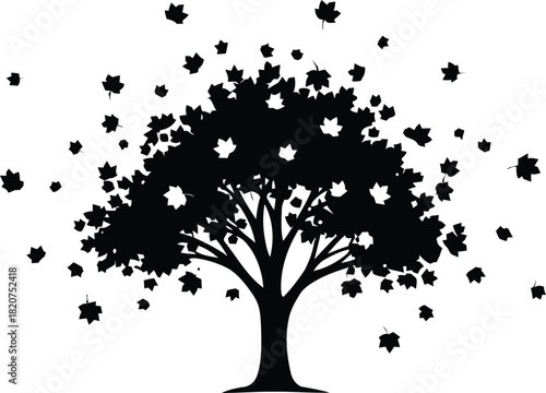 Silhouette of a tree with falling leaves