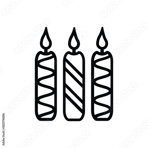 Three lit candles two striped with zigzags and one with diagonals stand sidebyside