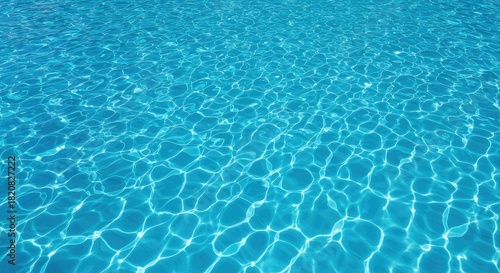 Crystal clear blue water reflecting bright summer sunshine on the rippling surface of an outdoor swimming pool, perfect for vacation relaxation ,hot ,background ,splash