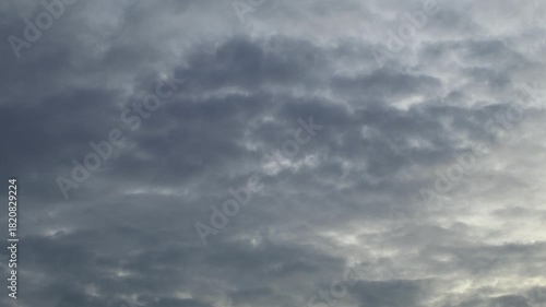 Dramatic storm clouds drifting across the blue sky in a timelapse scene