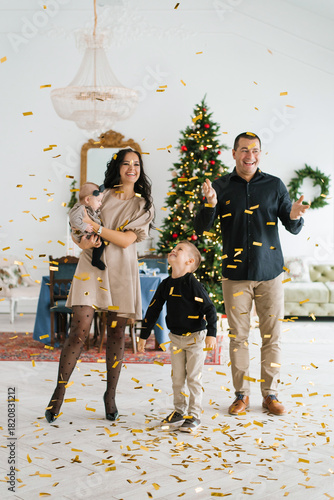 Smiling Parents With Children During Christmas Holiday Celebration