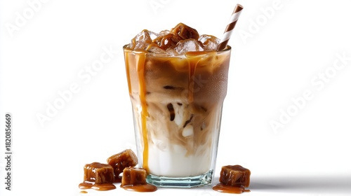Iced coffee caramel drink with milk and ice cubes in glass with striped straw, refreshing and sweet
