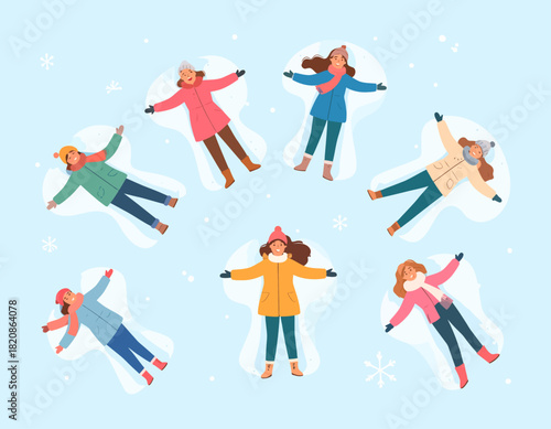 Seven women in winter clothing are making snow angels on a light blue snowy surface, creating angel shapes with their arms and legs.