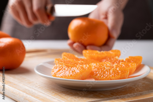 Fresh cut of Mandarin orange fruit preparing on plate ready to eating