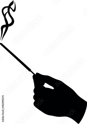 Elegant hand holding cigarette holder with smoke