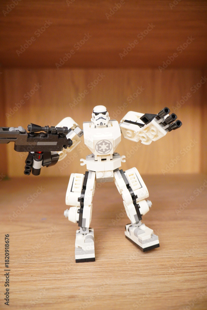 Naklejka premium Lego Stormtrooper robot figure standing on a wooden surface