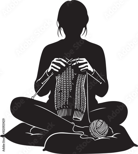 Silhouette of a person sitting cross-legged knitting with yarn and needles creating a textured fabric hobby