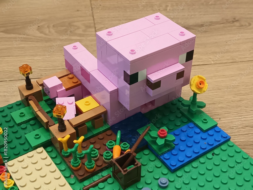 Obraz premium Minecraft Lego Building Set Features Pink Pig, Garden, and Water Features