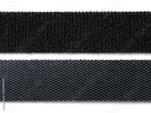A stack or roll of black reusable hook-and-loop straps, commonly used as cable ties or cord organizers. Essential for IT, home organization, and technology concepts.