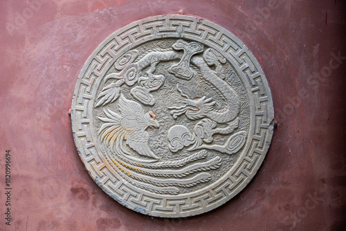 Decorative stone carving featuring dragon and phoenix