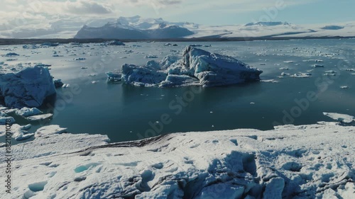 Wallpaper Mural Majestic icebergs breaking off a melting glacier and gliding through Iceland’s Jökulsárlón lagoon, creating a breathtaking Arctic landscape. Torontodigital.ca