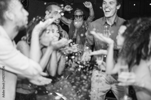 Canvas Print Young friends having party throwing confetti - Young people celebrating on weeke