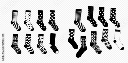 Collection of black and white socks with various patterns like stripes, polka dots, hearts, and geometric designs.