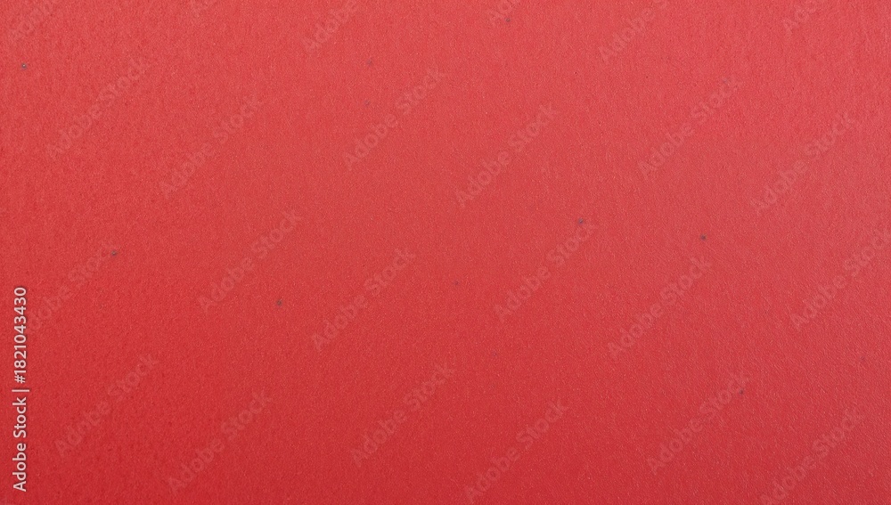 Fototapeta premium Filling red textured surface occupying entire frame on painted wall at studio, with fine grain