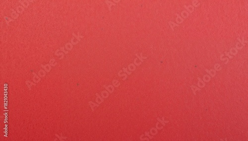 Filling red textured surface occupying entire frame on painted wall at studio, with fine grain