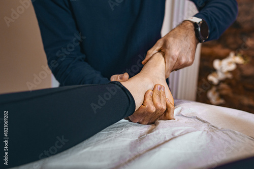 Foot and ankle mobility therapy performed by physiotherapist during manual treatment session