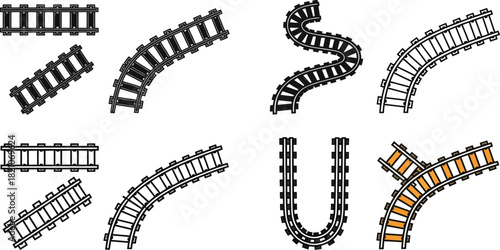 Various model train track pieces arranged in different curves and straight sections