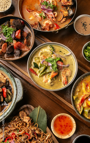 many different thai food dishes on table in modern restaurant in bangkok thailand