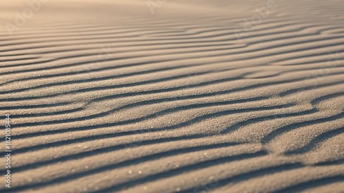 Close-up of gentle sand ripples in a serene desert landscape.