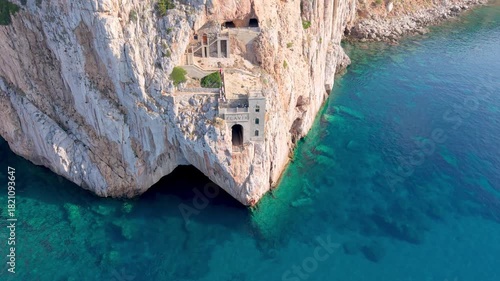  castle nestled on vertical cliffs above serene mediterranean coves near italy. Porto Flavia. 
