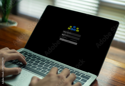person typing on a laptop with a login screen displayed, illustrating cybersecurity, user authentication, online account access, password protection, and secure digital identity management.