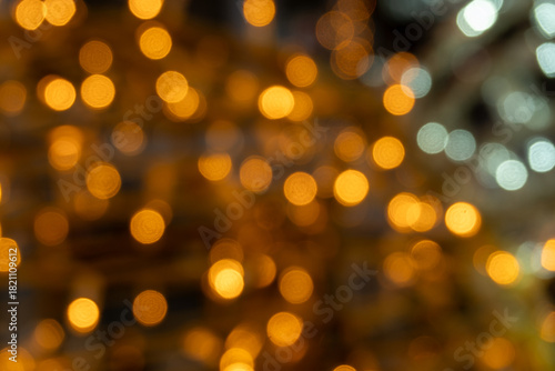 Golden and white bokeh light pattern with warm tones, abstract festive background for celebration or design use